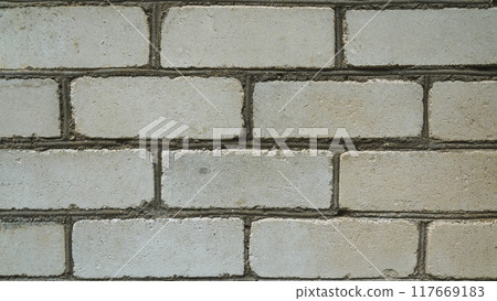 A white brick wall. White brick. The background is a white brick wall. Close up 117669183