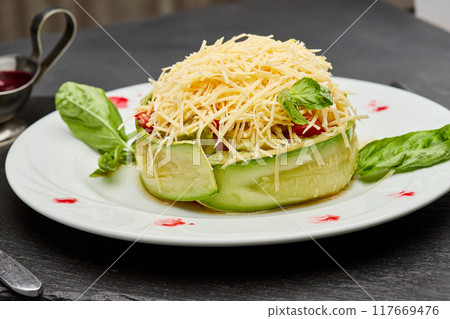 Fresh zucchini salad with parmesan cheese, basil leaves, and berry sauce on a gourmet plate 117669476