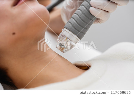 Treatment of women's facial skin in a beauty salon. Treatment of women's facial skin in a beauty salon. 117669635
