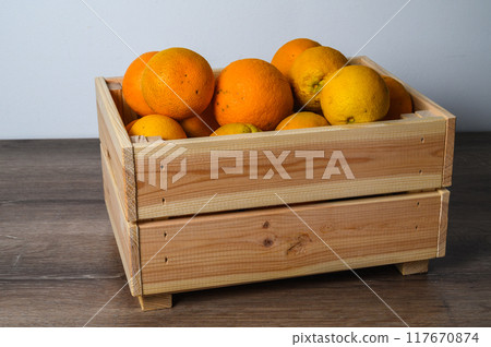 Fresh orange fruits box,High angle view of oranges in container on table 117670874