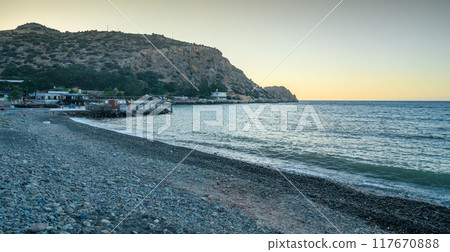 orange sunset over the sea and mountains 117670888