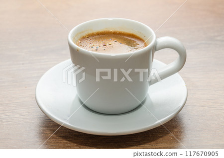 A cup of coffee on wooden table A cup of coffee on wooden table 117670905