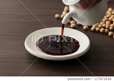 Soy sauce poured into a plate Soy sauce poured into a plate 117672016