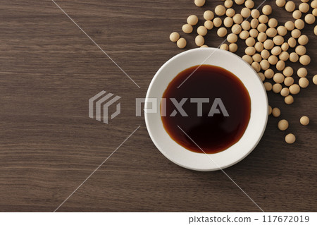 Soy sauce poured into a plate Soy sauce poured into a plate 117672019