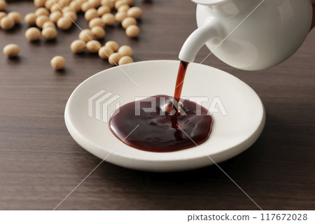 Soy sauce poured into a plate 117672028