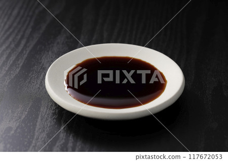 Soy sauce poured into a plate 117672053