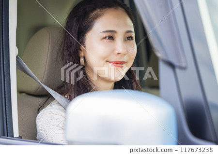 A young woman driving A young woman driving 117673238