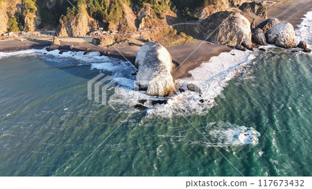 Large rocks natural monument Piedra de Iglecias Church stone on Chilean coast in Constitucion in sunset. 117673432