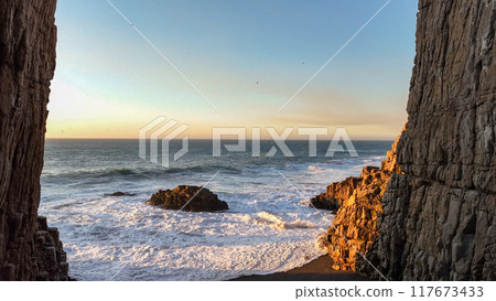 Large rocks natural monument Piedra de Iglecias Church stone on Chilean coast in Constitucion in sunset. Large rocks natural monument Piedra de Iglecias Church stone on Chilean coast in Constitucion in sunset. 117673433