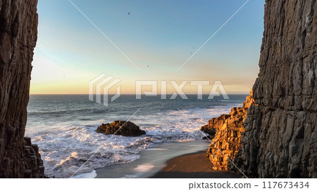 Large rocks natural monument Piedra de Iglecias Church stone on Chilean coast in Constitucion in sunset. 117673434