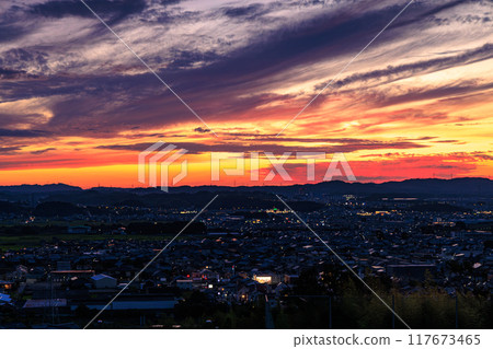 Evening view from Shiroyamadai in Kizugawa City, the southernmost part of Kyoto Prefecture. Sunset on the mountainside and the town lit up. On a hill overlooking the town of Kizu #1 Evening view from Shiroyamadai in Kizugawa City, the southernmost part of Kyoto Prefecture. Sunset on the mountainside and the town lit up. On a hill overlooking the town of Kizu #1 117673465