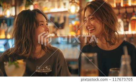 Japanese women enjoying conversation at a cafe bar at night 117673705