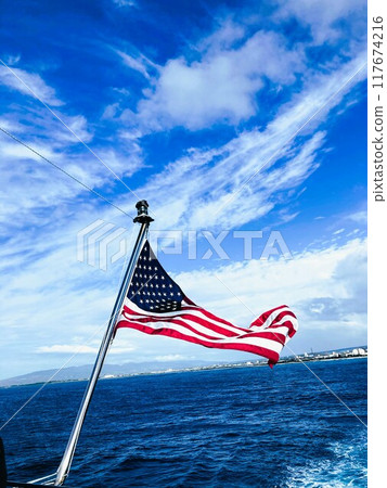The Stars and Stripes fluttering in the wind, their strength symbolizes freedom and pride. The Stars and Stripes fluttering in the wind, their strength symbolizes freedom and pride. 117674216