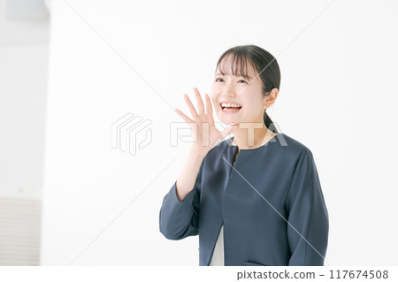 A woman in her twenties wearing a navy blue jacket A woman in her twenties wearing a navy blue jacket 117674508