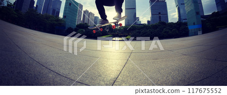 Skateboarder skateboarding outdoors in city Skateboarder skateboarding outdoors in city 117675552