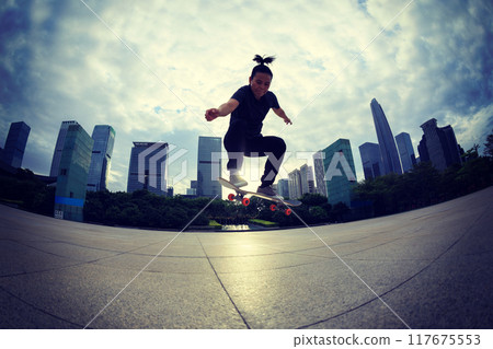 Skateboarder skateboarding outdoors in city 117675553
