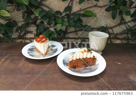 carrot cake with cream and walnut topping ,caramel macadamia cheesecake and hot tea carrot cake with cream and walnut topping ,caramel macadamia cheesecake and hot tea 117675963