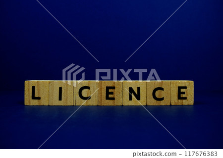 Licence with wooden blocks alphabet letters on blue background Licence with wooden blocks alphabet letters on blue background 117676383