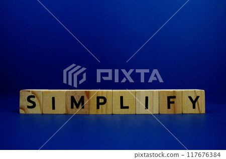 Simplify with wooden blocks alphabet letters and Magnifying glass on blue background Simplify with wooden blocks alphabet letters and Magnifying glass on blue background 117676384