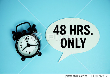 48 Hrs only text on speech bluble with alarm clock top view on blue background 48 Hrs only text on speech bluble with alarm clock top view on blue background 117676997