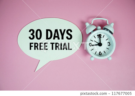 30 Days Free trial text on speech bluble with alarm clock top view on pink background 30 Days Free trial text on speech bluble with alarm clock top view on pink background 117677005