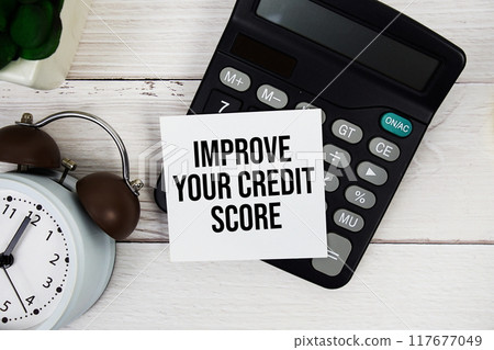 Improve Your Credit Score text message with calculate and alarm clock top view on wooden background 117677049