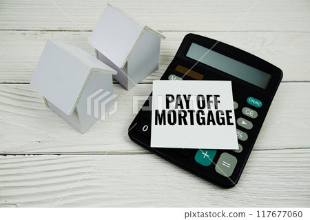 Pay Off Mortgage text message with calculate and house model on wooden background 117677060