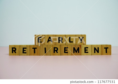 wooden blocks alphabet letters EARLY RETIREMENT on pink background 117677531