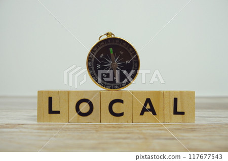 Compass with wooden blocks alphabet letters LOCAL on wooden background Compass with wooden blocks alphabet letters LOCAL on wooden background 117677543