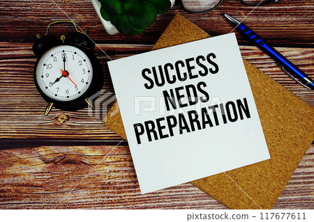 Success Needs Preparation text written on paper torn with pen top view on wooden background 117677611