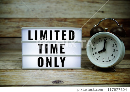 Limited Time Only text on LED lightbox with alarm clock on wooden background Limited Time Only text on LED lightbox with alarm clock on wooden background 117677804
