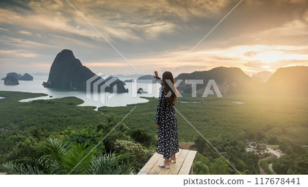 woman enjoy Phang Nga Bay from Samed Nangshe viewpoint at sunrise 117678441
