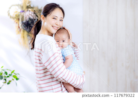 A woman holding a baby A woman holding a baby 117679322