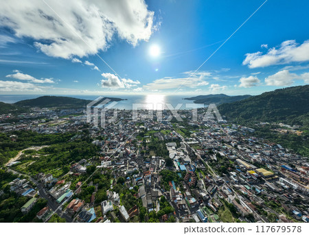 Phuket Thailand patong bay. Panorama landscape nature view from Drone camera. Aerial view of patong city in phuket thailand. Beautiful sea in summer sunny day time Phuket Thailand patong bay. Panorama landscape nature view from Drone camera. Aerial view of patong city in phuket thailand. Beautiful sea in summer sunny day time 117679578