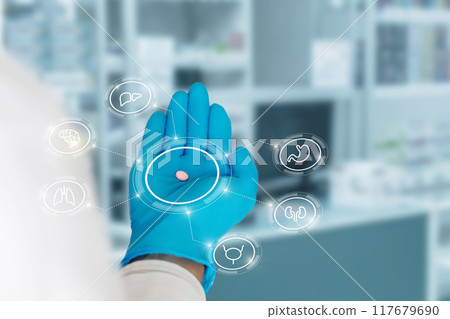 A gloved hand holding a pill surrounded by organ icons. 117679690