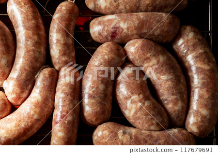 Concept of making homemade grilled sausages. 117679691