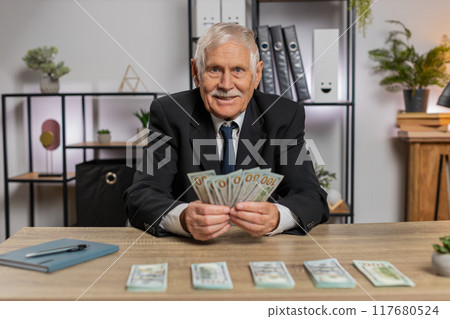 Rich Caucasian senior businessman counting money cash calculate earnings income profit at home Rich Caucasian senior businessman counting money cash calculate earnings income profit at home 117680524
