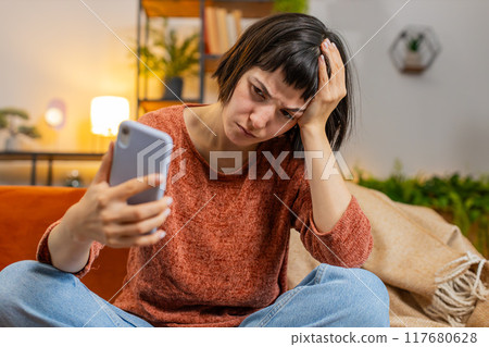 Upset displeased woman using smartphone surprised by lottery results or bad news loses fail game Upset displeased woman using smartphone surprised by lottery results or bad news loses fail game 117680628