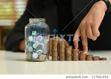 Fingers walking up on stack of coins. Concept of saving money and the importance of financial planning 117681858