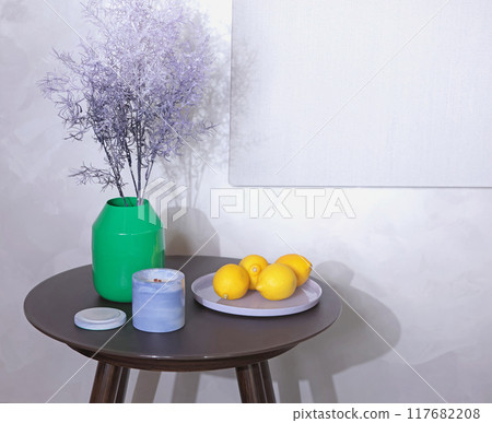 Coffee table with items in lavender and green color palette. Yellow lemons in glass plate. Linen canvas for painting. Mockup for design. Coffee table with items in lavender and green color palette. Yellow lemons in glass plate. Linen canvas for painting. Mockup for design. 117682208