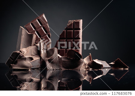 Pieces of dark chocolate. 117683076