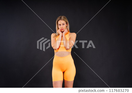 Portrait, fitness or body of young woman in studio isolated on a yellow black red background. 117683270