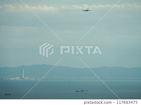 Scenery of Osaka Bay with planes flying towards Kansai Airport Scenery of Osaka Bay with planes flying towards Kansai Airport 117683475