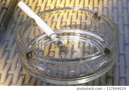 Cigarettes on an ashtray 117684029