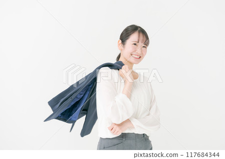 Woman putting suit jacket over shoulder 117684344