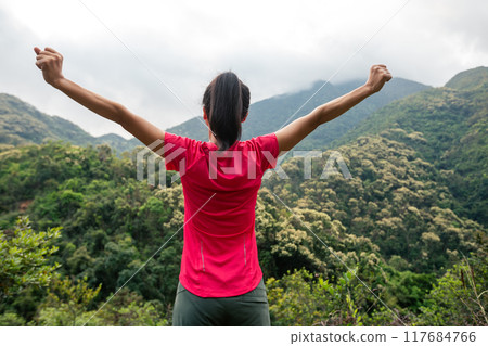 Cheering happy woman feel free on spring morning mountain top 117684766