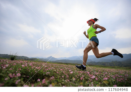 Woman runner running in spring Woman runner running in spring 117684948