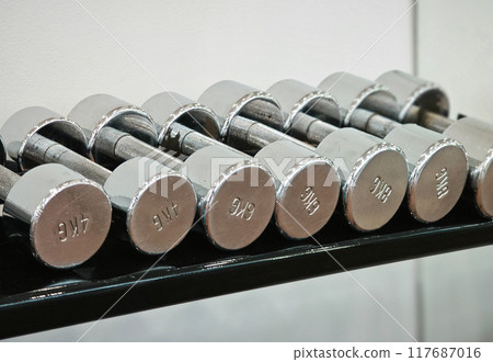 Dumbbell at fitness Gym to build muscle ,Sports equipment in gym. Dumbbell at fitness Gym to build muscle ,Sports equipment in gym. 117687016