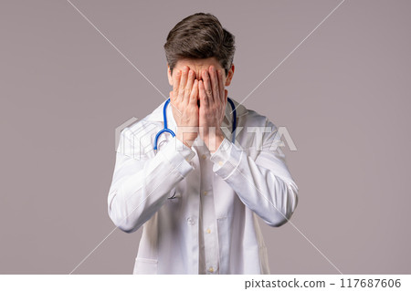 Disappointed doctor man doing facepalm. Feeling regret, failure, dissatisfaction, wasted time Disappointed doctor man doing facepalm. Feeling regret, failure, dissatisfaction, wasted time 117687606