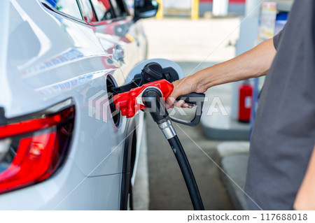 A man who refuels at a gas station A man who refuels at a gas station 117688018